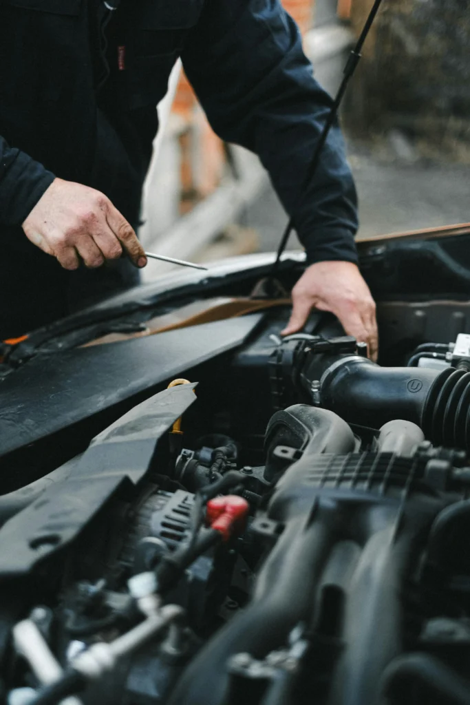 man fixing car